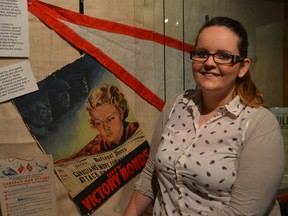 Emily McKenzie, summer student with the Elgin Military Museum, stands beside one of the exhibits featured at the Talbot Street facility, on July 8, 2014. McKenzie is hoping to chronicle wartime accounts of local women during World War II.  (DON BIGGS, Times-Journal)