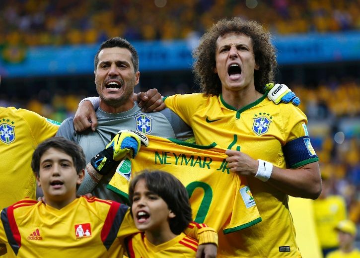 David Luiz of Brazil holds up Neymar's shirt prior to the 2014