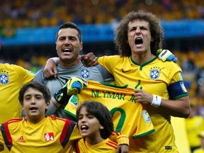Brazil's David Luiz and goalkeeper Julio Cesar hold the jersey of Neymar before the 2014 World Cup semi-finals between Brazil and Germany at the Mineirao stadium in Belo Horizonte July 8, 2014. (REUTERS/Eddie Keogh)