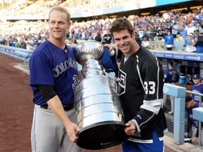 Justin Morneau of the Colorado Rockies (left) is enlisting help from some of his hockey friends, such as defenceman Willie Mitchell (right), to get enough votes to join the National League all-star team. (RICHARD MACKSON/USA TODAY Sports)