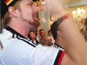A fan in a Toronto bar cheers on the German soccer team. (ANGELA HENNESSY, Toronto Sun)