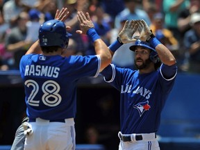 Blue Jays outfielder Darin Mastroianni (right) is greeted at home plate by  Colby Rasmus after driving them both in with a two-run home run on June 28. Mastroianni and Rasmus will be sharing centre field under a platoon arrangement. (DAN HAMILTON/USA TODAY Sports)