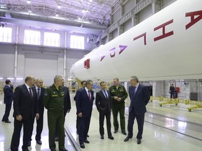Russia's Prime Minister Dmitry Medvedev (3rd R) inspects the test carcass of the new generation Angara rocket, which is under construction, with Defence Minister Sergei Shoigu (4th R).

REUTERS/Alexander Astafyev/RIA Novosti/Pool