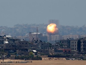 An explosion is seen after an air strike in northern Gaza July 9, 2014. Militants in Gaza fired more rockets at Tel Aviv on Wednesday, targeting Israel's heartland after Israeli attacks in the enclave that Palestinian officials said have killed at least 27 people. REUTERS/Ronen Zvulun