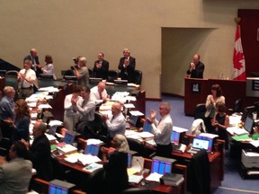 Mayor Rob Ford remains seated while council gives a standing ovation to city staff and volunteers that worked on World Pride Toronto. (DON PEAT/Toronto Sun)