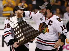 Chicago Blackhawks' Jonathan Toews congratulates teammate Patrick Kane after he was named the Conn Smythe trophy winner following Game 6 of the Stanley Cup Final on June 24, 2013. (REUTERS/Winslow Townson)