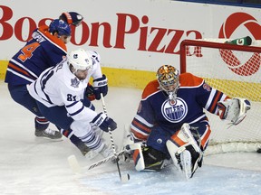 Edmonton Oilers goaltender Richard Bachman (30) is scored on by Toronto Maple Leafs forward Phil Kessel (81) during the first period of an NHL game at Rexall Place in Edmonton, Alta., on Tuesday, Oct. 29, 2013. Ian Kucerak/Edmonton Sun/QMI Agency