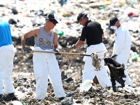 Authorities comb Spyhill landfill Wednesday July 9, 2014 in northwest Calgary in the ongoing search for missing Calgarians Nathan O'Brien and his grandparents Alvin and Kathy Liknes. The search expanded to a second landfill site in southeast Calgary on Thursday. (Jim Wells/Calgary Sun)
