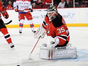 Cory Schneider #35 of the New Jersey Devils stops a shot in the first period against the Washington Capitals at Prudential Center on January 24, 2014 in Newark, New Jersey.  Elsa/Getty Images/AFP