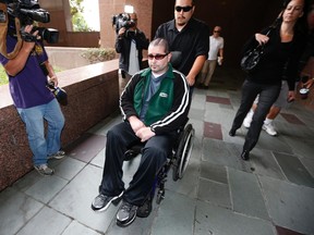 Giants fan Bryan Stow (centre) arrives with his sister Bonnie Stow (right) at a Los Angeles Court the day before closing arguments in a civil trial in a lawsuit against former Dodgers owner Frank McCourt last month. A jury ordered the Dodgers to pay Stow about $15 million on Wednesday. (Lucy Nicholson/Reuters/Files)