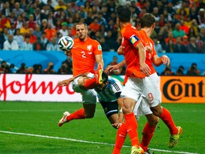 Argentina's Ezequiel Garay is kicked in the head by Ron Vlaar of the Netherlands during a corner attempt in their World Cup semifinal game at Corinthians Arena in Sao Paulo, Brazil, July 9, 2014. (MICHAEL DALDER/Reuters)