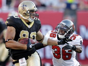 New Orleans Saints' tight end Jimmy Graham (80) is caught by Tampa Bay Buccaneers' defensive back Tanard Jackson (36) after a gain of 43 yards during their NFL football game in Tampa, Florida October 16, 2011.  REUTERS/Pierre DuCharme