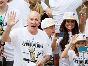 San Antonio Spurs head coach Gregg Popovich waves to the fans during the NBA championship parade at San Antonio River Walk on Jun 18, 2014 in San Antonio, TX, USA. (Soobum Im/USA TODAY Sports)