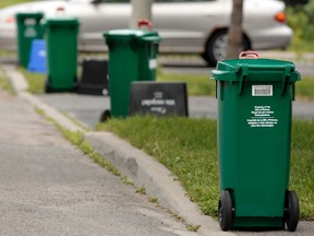 Green bins sit along a street for pickup in a Ottawa neighborhood on Wednesday July 9, 2014. Tony Caldwell/Ottawa Sun/QMI Agency