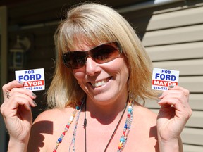 LeeAnne McRobb, who met Toronto Mayor Rob Ford in rehab in Muskoka in May and was charged with driving his vehicle while impaired, speaks to the Toronto Sun in Bala on Wednesday July 9, 2014. She is holding Ford fridge magnets which she found in his vehicle and took with his permission. (Michael Peake/Toronto Sun)