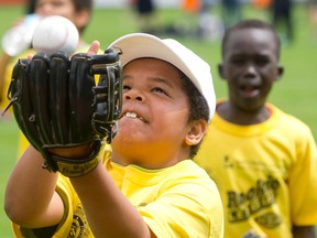 Daishawn Taylor keeps his eye on a pop fly as it drops into his glove while joining other kids as they practice for their Rookie League baseball games at Labatt Memorial Park in London. (CRAIG GLOVER, The London Free Press)