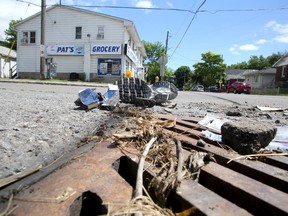 Items are strewn on the street at the intersection of Patrick and John streets in Kingston on July 9, the day after a collision between an SUV and a motorcycle that sent two people to hospital. The Special Investigations Unit is investigating.