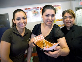 Ivette Calderon, middle, shows off a bego, the signature Mexican dish at Begos. With her are her sister, Iris Calderon, left, and mother, Diana Calderon at the eatery at 129 Dundas St. (CRAIG GLOVER, The London Free Press)