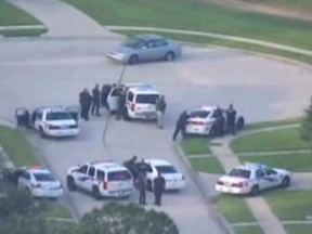 A still image taken from KPRC-TV aerial video footage shows police and a suspect in a standoff at a residential neighborhood, following a shooting incident in Spring, Texas July 9, 2014.    REUTERS/KPRC-TV