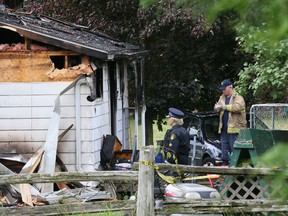 Investigators from the office of the Ontario Fire Marshal and Grey County OPP at the scene of a house fire on Sideroad 115 near Jackson in Georgian Bluffs on Wednesday. Police confirmed Thursday morning that a body was found inside the house. The fire also sent four people to hospital. (James Masters/The Sun Times)