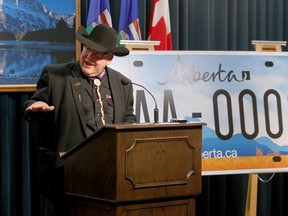 Alberta Premier Dave Hancock is shown in Calgary, Alta., July 8, 2014, as he introduces one of the new licence plate designs up for vote on the province's website. (Jim Wells/QMI Agency)
