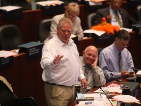 Councillor Doug Ford responds to heckling at council on Thursday, July 10, 2014. (JACK BOLAND/Toronto Sun)