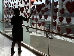 A woman looks at some hearts on display at the Mazankowski  Alberta Heart Institute during Hear Pledge Day at the UofA in Edmonton, Alberta on Feb26, 2014.  630 CHED Radiothon help raise funds to support the purchase an Arctic Sun System and buy time for heart attack patients.  Photo by Trent Wilkie/Edmonton Sun/QMI Agency
