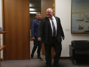 Mayor Rob Ford and Bob Marier, his sobriety coach, on their way to a council meeting Thursday, July 10, 2014. (JACK BOLAND/Toronto Sun)