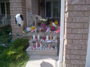 A memorial outside the Mississauga home of Tyrese, Santosh, and their father Samuel Masih, who were found dead in a burned-out vehicle north of Barrie last Friday. (Terry Davidson/Toronto Sun)