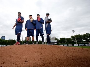London Majors pitchers Carlos Martinez, left, Deinys Suarez, Jonady Nunez, and Wander Perez pose for a photo on the pitcher's mound at Labatt Memorial Park in London. CRAIG GLOVER/The London Free Press/QMI Agency
