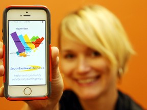 The LHIN's Caitlin den Boer holds a phone running the new South East HealthLine application. It's a quick way to find nearby health services.