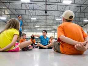 Andre Pedreros points to a fellow camper he thinks is hiding a rubber chicken behind their back at a day camp at Kinsmen Arena in London this week. City and local non-profits support camps for special needs? kids who may need more support than a conventional camp offers. (CRAIG GLOVER, The London Free Press)