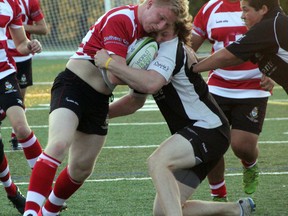 Sam Freeth (left) of the Halliford School Rugby Club and Christian Lyle (right) of the Sarnia Saints U18 Squad, battle during an international friendly at Norm Perry Park on Thursday, July 10. Halliford is a secondary school in Surrey, England, and is on a tour of Ontario. (SHAUN BISSON, The Observer)