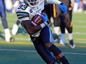 Terrell Sinkfield, shown running the ball for the Argos during a pre-season game against the Ticats, is set to make his regular-season pro football debut on Saturday. (AFP/PHOTO)