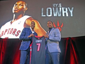 Raptors GM Masai Ujiri (left) and Kyle Lowry pose after announcing the point guard has re-signed with the team. (JACK BOLAND/Toronto Sun)