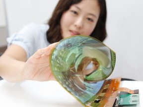 LG's 18-inch flexible OLED panel can be rolled up into a 3 cm tube. (LG Display/Handout)