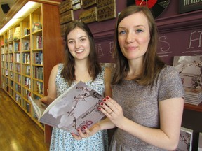 Copies of Sarnia: 100 Years, a photo book published by the city's centennial celebration committee, are now on sale. Booksellers Kennedy Rooke, left, and Erin Wiley hold a copy at The Book Keeper, on Exmouth Street in Sarnia. The book is also available at city hall.
(Paul Morden/ The Observer)