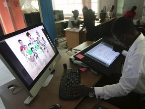 An illustrator works on a digital drawing board at the Kuluya Games office at Anthony district in Nigeria's commercial capital of Lagos June 16, 2014.  REUTERS/Akintunde Akinleye