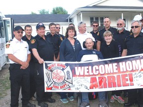 Arrie Turner is surrounded by family and Rodney firefighters after returning home from Parkwood hospital following six months of treatment.