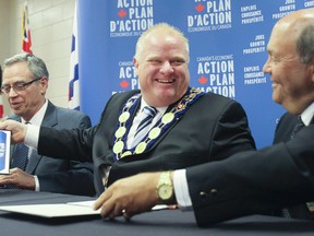 Federal Finance Minister Joe Oliver, left, Toronto Mayor Rob Ford and Russ Powers, president of the Association of Municipalities of Ontario on July 11, 2014. (STAN BEHAL/Toronto Sun)