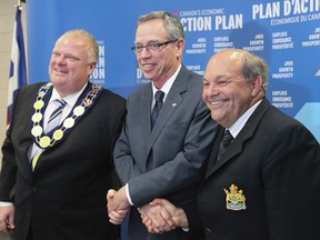 Federal Finance Minister Joe Oliver,centre, Toronto Mayor Rob Ford, left,and Russ Powers president of the Association of Municipalities of Ontario celebrated an agreement in Toronto on July 11, 2014 for the renewed federal gas tax fund that provides stable funding for public infrastructure across Ontario. (Stan Behal/Toronto Sun)