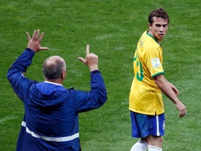 Brazil's coach Luiz Felipe Scolari (L) gestures to Bernard during their 2014 World Cup semi-finals against Germany at the Mineirao stadium in Belo Horizonte. REUTERS/David Gray/Files