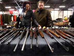 (left to right) Patrizia Cimmino and Sandro Cerminara look at rifles on display at the Canadian Historical Arms Society Gun Show at the Edmonton Expo Centre in Edmonton, Alta. on Saturday Jan. 26, 2013. The show continues Sunday from 9:30 a.m. to 4 p.m. David Bloom/Edmonton Sun/ QMI Agency