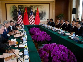 U.S. Secretary of State John Kerry (3rd L), speaks next to U.S. Treasury Secretary Jack Lew (4th L) as they attend the Climate Change issue joint conference with Chinese State Council Yang Jiechi (R) at the Fanghuayuan Hall,  Diaoyutai State Guest House in Beijing July 9, 2014. 

REUTERS/Andy Wong/Pool