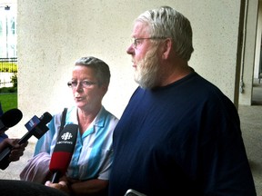 Victims Stan and Beryle Pledge speaking to the media outside the downtown court house following the sentencing of Arnold Donszelmann in Edmonton, Alberta on July 11, 2014. The former recreational vehicle dealership owner was sentenced to seven years in prison on Friday and ordered to pay $2.3 million in restitution.  Tony Blais/Edmonton Sun/QMI Agency