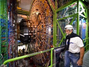 (FILES) -- A file picture taken on July 19, 2013 shows a worker walking past the Compact Muon Solenoid (CMS), a general-purpose detector at the European Organisation for Nuclear Research (CERN) Large Hadron Collider (LHC), during maintenance work in Meyrin, near Geneva. Europe's physics lab CERN said on February 6, 2014 it was eyeing plans for a circular particle collider that would be seven times more powerful than the facility which discovered the famous "God particle."  AFP PHOTO / FABRICE COFFRINI
