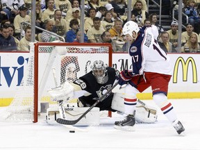 Pittsburgh Penguins goalie Marc-Andre Fleury (29) makes a save against Columbus Blue Jackets center Brandon Dubinsky (17)at the CONSOL Energy Center. Mandatory Credit: Charles LeClaire-USA TODAY Sports