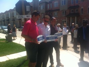 Former Leafs Mark Osborne, left, and Wendel Clark, right, were among those on hand in Scarbrough on July 11, 2014 when the street signs for Zezel Way were unveiled. (Photo courtesy torontomapleleafs.com)