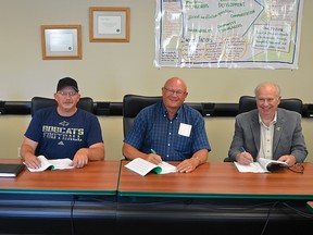 Union members and council members sign the four-year contract between public employees and the town. From left to right: Public works coordinator Blaise Bruder, CUPE Local 927 president Tony Naumczyk, Councillor Doug Thornton and Pincher Creek Mayor Don Anderberg. John Stoesser photo/QMI Agency.