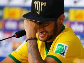 Injured Brazilian national soccer team player Neymar cries during a news conference in Teresopolis, near Rio de Janeiro, July 10, 2014. (REUTERS/Marcelo Regua)